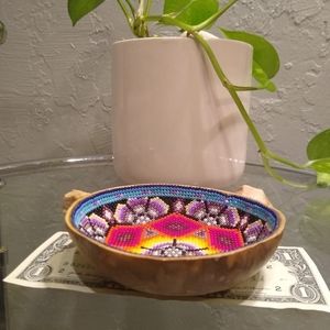 This is a wooden bowl with beads